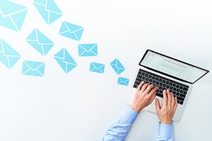 letters flying into a laptop