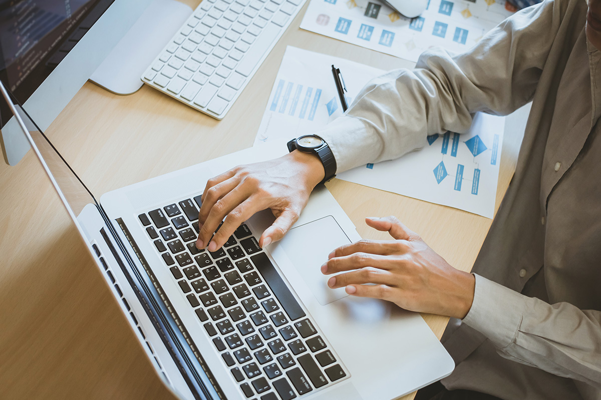 person on laptop looking at charts and data