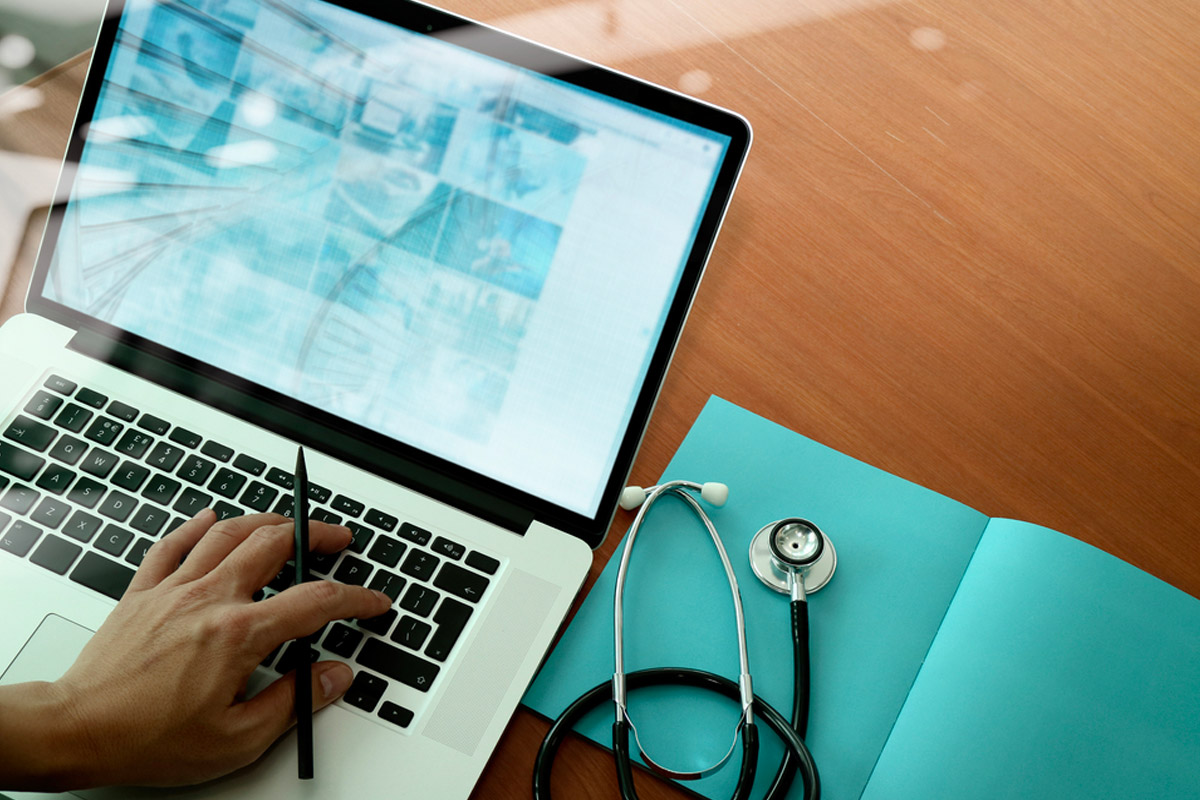 a doctor browsing on a laptop