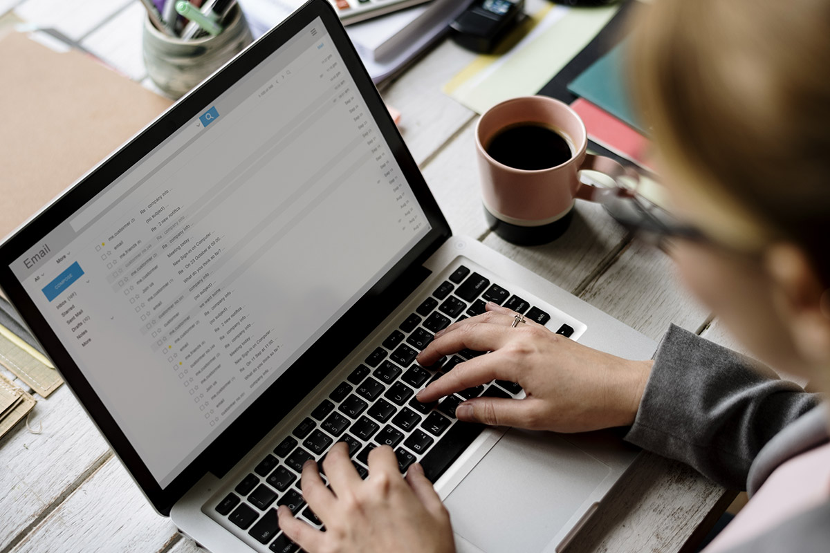 Businesswoman Checking E-mail Online on Laptop