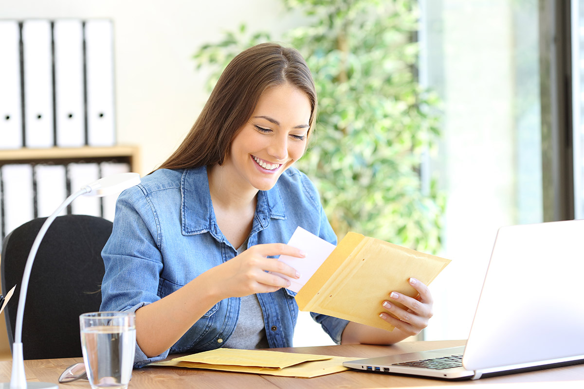 woman opening mailer