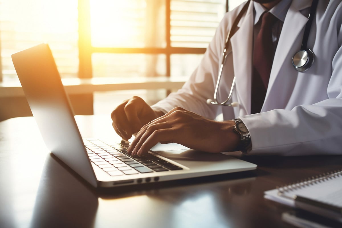 pharmacist using a laptop in a sunny room