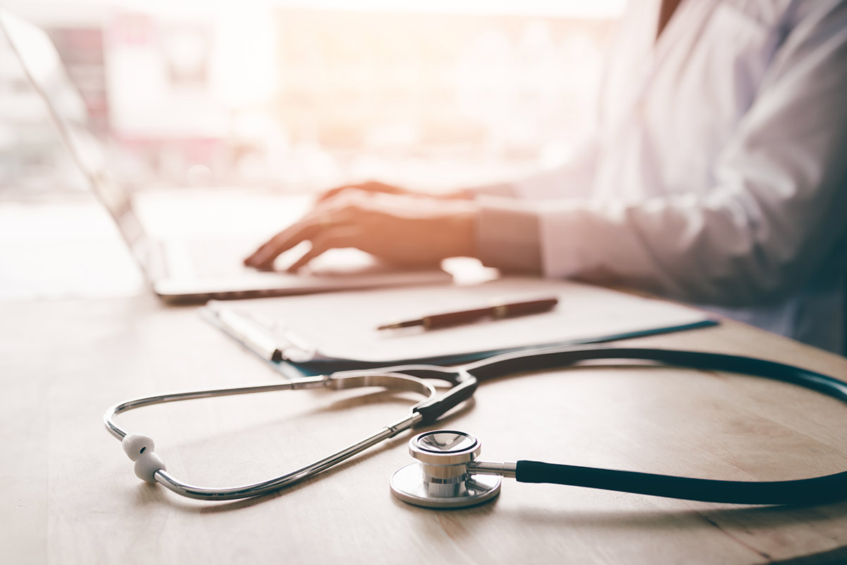 doctor using laptop at his desk