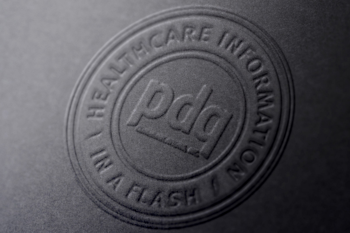 PDQ logo embossed on black paper